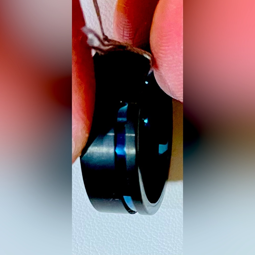 Gents black  tungsten carbide with blue lining inside of band.